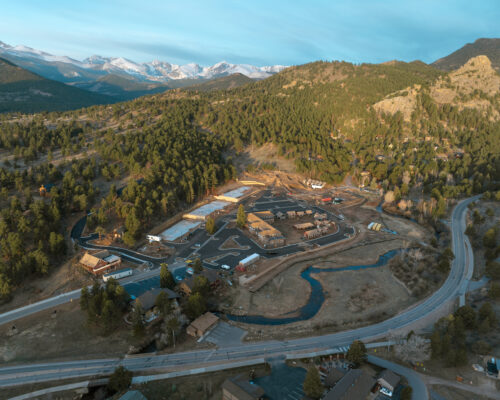 Aerial view of a mountain town with snowy peaks.