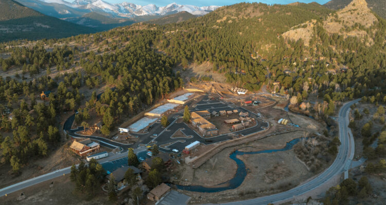Aerial view of a mountain town with snowy peaks.