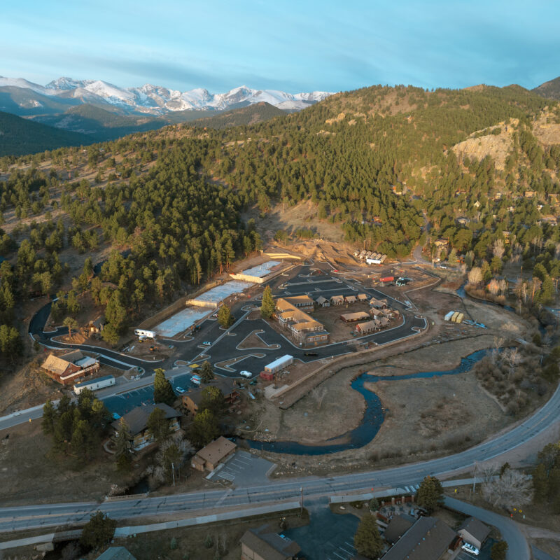 Aerial view of a mountain town with snowy peaks.